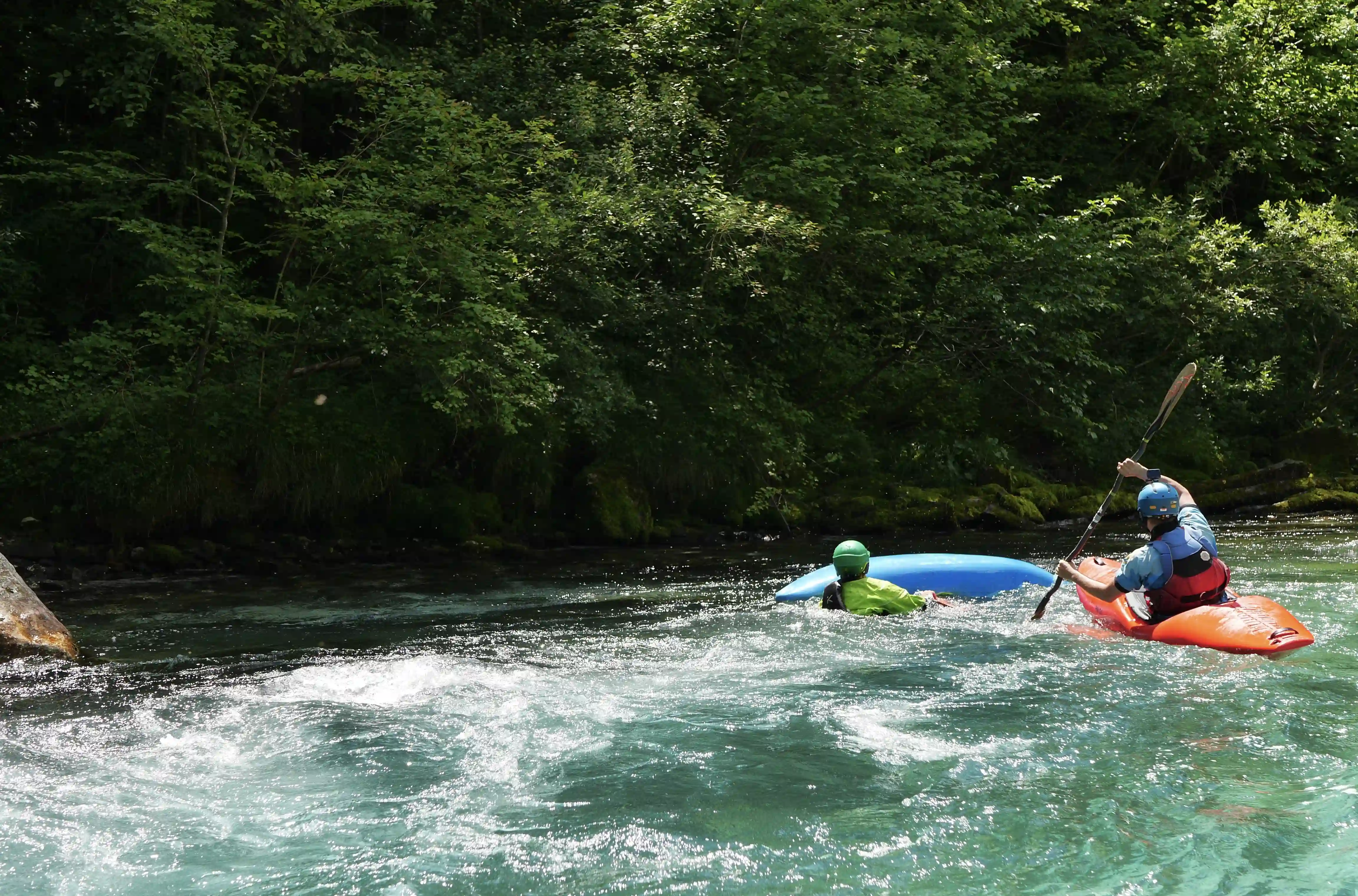 Kayaker swimming on the Soca river