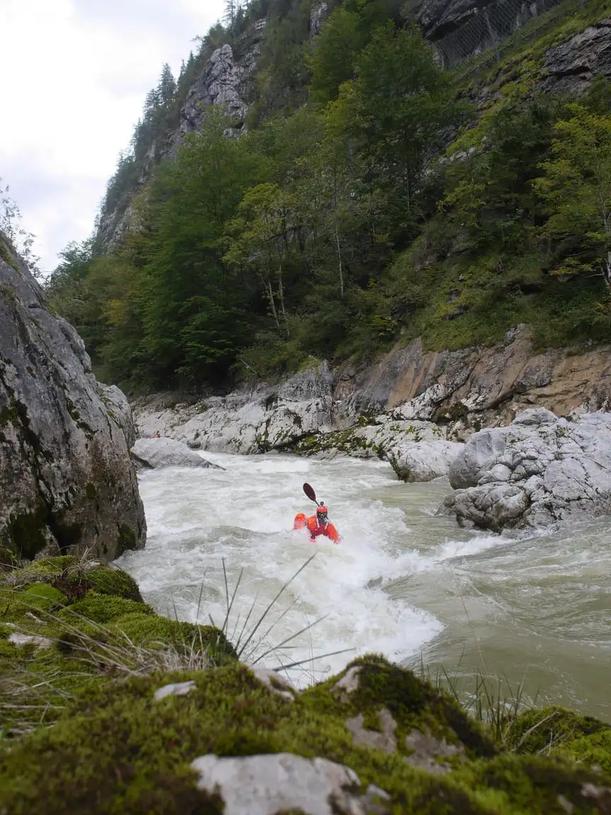 Kayaking down a rapid on the Enns river