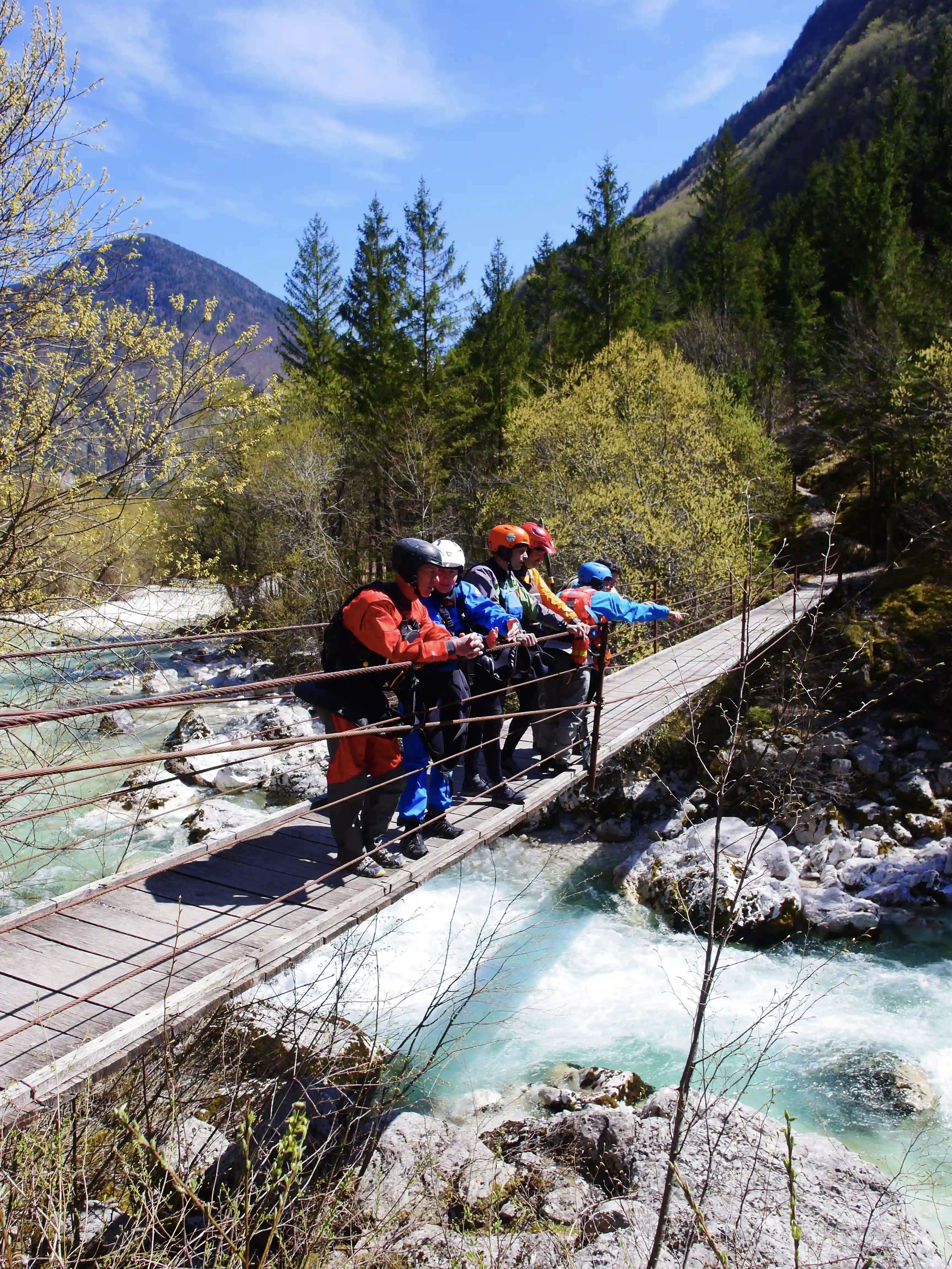 Scouting a rapid on a blue river bridge